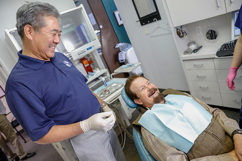 Dr. Ikemiya treating a patient at Monterey Peninsula Dental Group